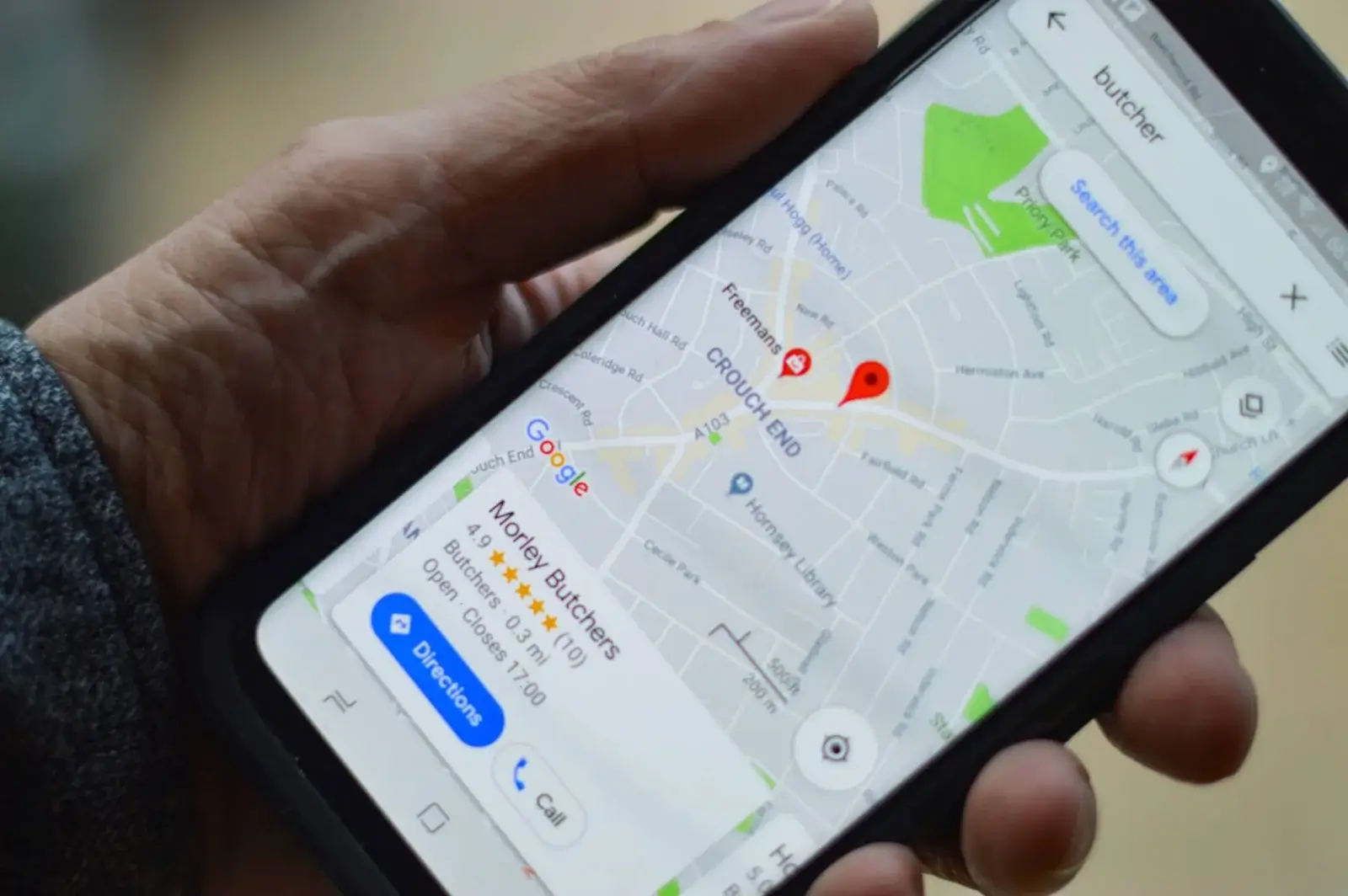 Local SEO ranking factors in practice: A smartphone showing a Google Maps local search for a butcher, with a top-ranked business listing, its star rating and directions button